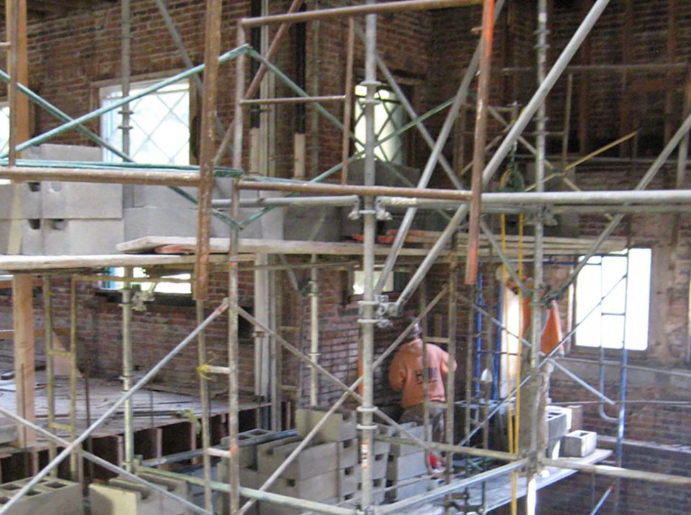Seismic reinforcing being placed in walls built in 1906